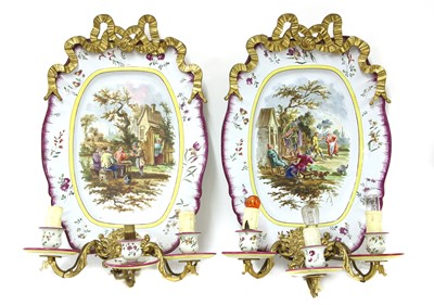 Lot 235 - A pair of French faience wall lights
