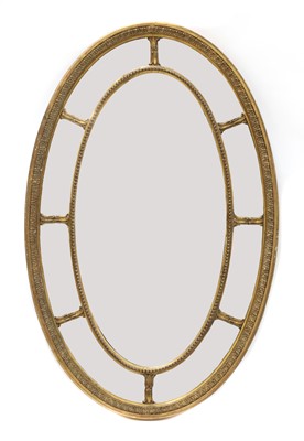 Lot 414 - A carved giltwood and gesso oval wall mirror