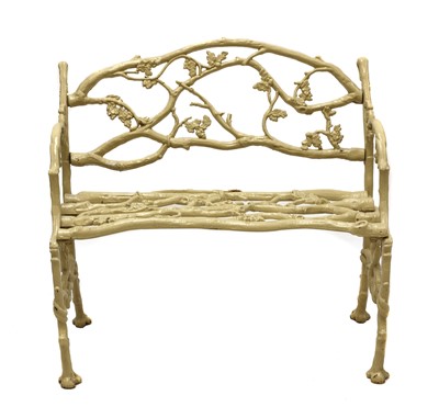Lot 986 - A small faux bois cast iron garden seat