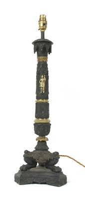 Lot 360 - An Empire style ornately ebonised brass table lamp