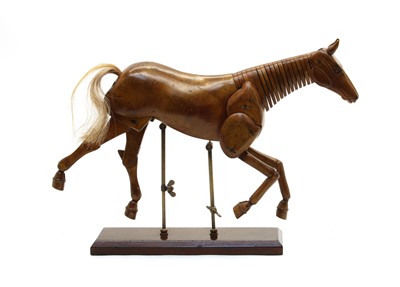 Lot 561 - A carved wooden articulated horse