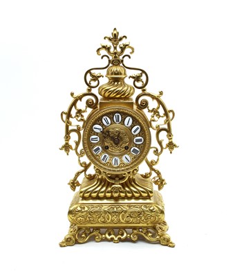 Lot 570 - A French ornate brass mantle clock