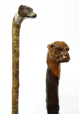 Lot 755 - Two dog's head walking sticks