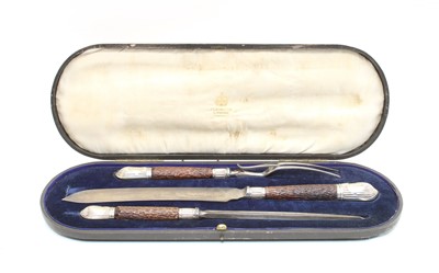 Lot 506 - A cased horn handled and silver mounted carving set