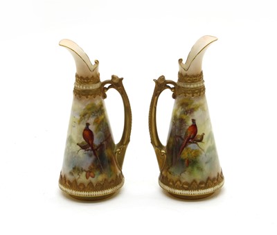 Lot 590 - A pair of Royal Worcester hand painted ewer jugs by FJ. Bray