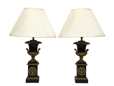 Lot 222 - A pair of Napoleon III ebonised and gilt metal urn form table lamps