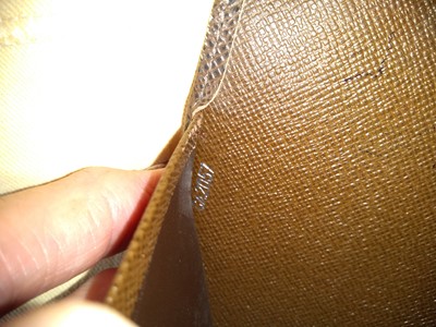 Lot 142 - A Louis Vuitton brown taiga leather desk agenda cover