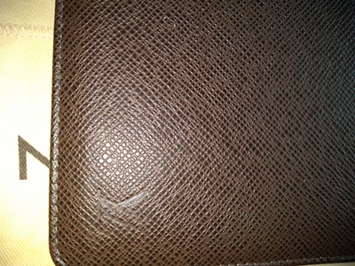Lot 142 - A Louis Vuitton brown taiga leather desk agenda cover