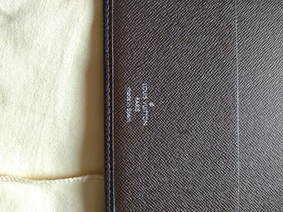Lot 142 - A Louis Vuitton brown taiga leather desk agenda cover