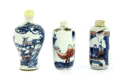 Lot 253 - Three Chinese underglaze blue and copper-red porcelain snuff bottles