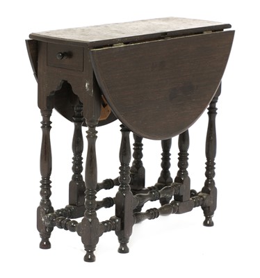Lot 709 - A miniature ebony gateleg table
