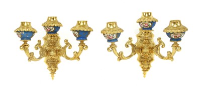 Lot 493 - A pair of gilt-bronze three-light wall appliqués
