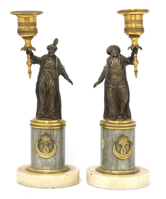 Lot 852 - A pair of French gilt and patinated bronze figural 'gout en turc' candlesticks