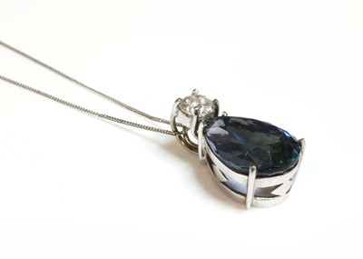 Lot 362 - A white gold two stone tanzanite and diamond pendant