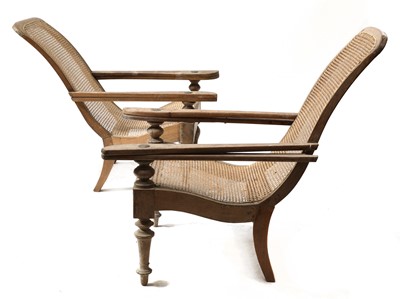Lot 134 - A near pair of teak planter's lounge chairs