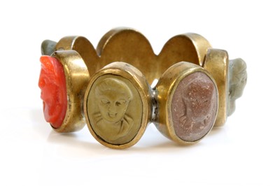 Lot 8 - A late Georgian gilt metal specimen lava and coral cameo ring