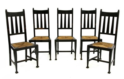 Lot 165 - A set of five Arts and Crafts oak and ebonised chairs