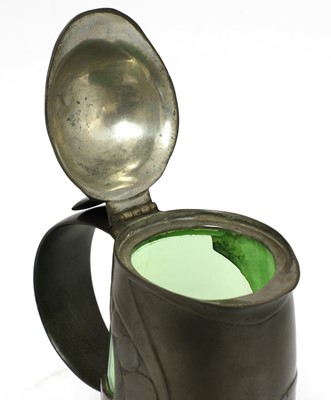 Lot 124 - A Tudric pewter and green glass claret jug and cover