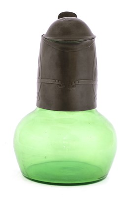 Lot 124 - A Tudric pewter and green glass claret jug and cover