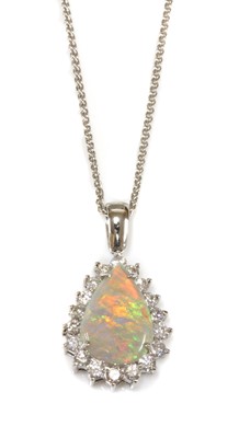 Lot 169 - A white gold opal and diamond pear-shaped cluster pendant