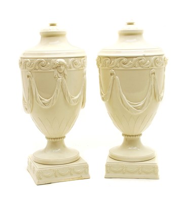 Lot 137 - A pair of Wedgwood embossed Queensware urns