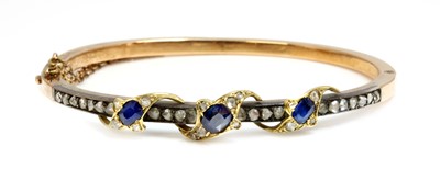 Lot 74 - A sapphire and diamond hinged bangle