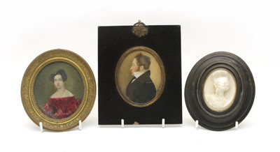 Lot 144 - An Edwardian miniature portrait of a woman in a red dress