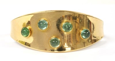 Lot 19 - A gold gem-set torque bangle