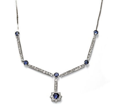 Lot 454 - An 18ct white gold sapphire and diamond cluster necklace, c.1970