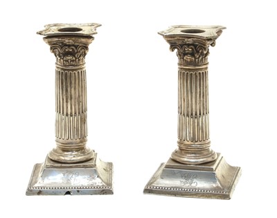 Lot 15 - A pair of silver candlesticks