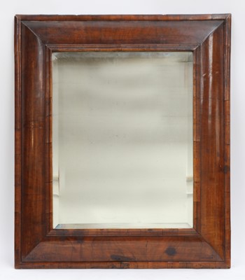 Lot 284 - A walnut cushion-framed wall mirror