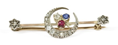 Lot 13 - A gold and silver, diamond, ruby and sapphire crescent bar brooch