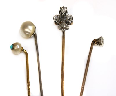 Lot 51 - A cased diamond set fleur-de-lys stick pin, early 20th century