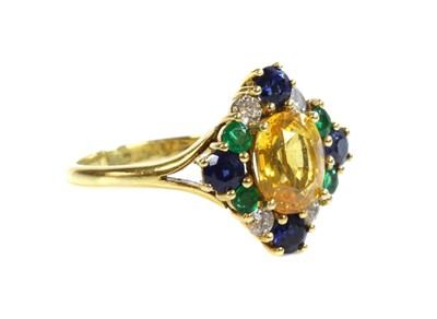 Lot 308 - An 18ct gold, yellow sapphire, blue sapphire, emerald and diamond cluster ring