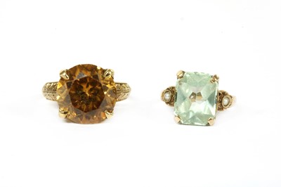 Lot 184 - An American gold single stone orange zircon ring