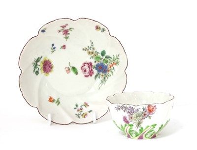 Lot 943 - A Chelsea Red Anchor period lobed tea bowl and saucer