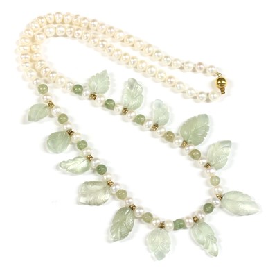 Lot 188 - A single row carved bead and freshwater cultured pearl necklace