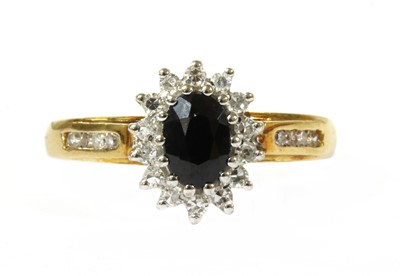 Lot 204 - An 18ct gold sapphire and diamond cluster ring