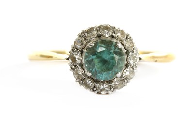 Lot 283 - A gold blue zircon and diamond halo cluster ring