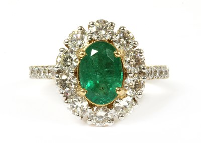 Lot 216 - A gold emerald and diamond cluster ring