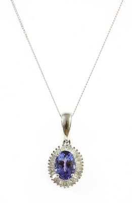Lot 295 - A white gold tanzanite and diamond cluster pendant