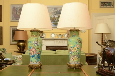 Lot 84 - A pair of chinoiserie-decorated pottery and gilt metal mounted table lamps