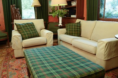 Lot 203 - A yellow tweed upholstered two-seater settee