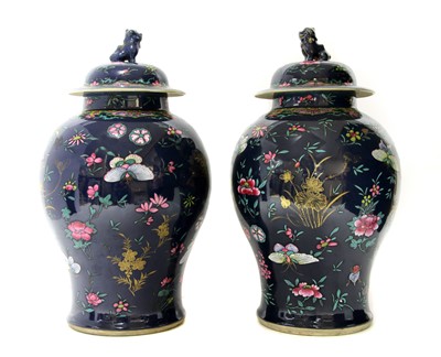 Lot 230 - A pair of Chinese famille rose jars and covers