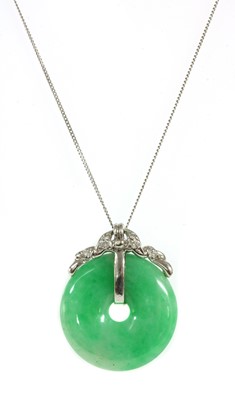 Lot 200 - A white gold jadeite jade bi and diamond pendant