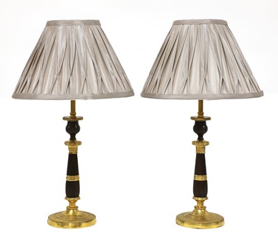 Lot 107 - A pair of French Empire-style bronze and gilt-bronze candlesticks
