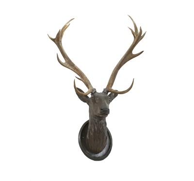 Lot 273 - A Black Forest carved wood stag's head, with mounted antlers