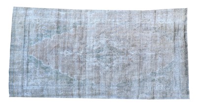 Lot 843 - A vintage Persian overdyed carpet