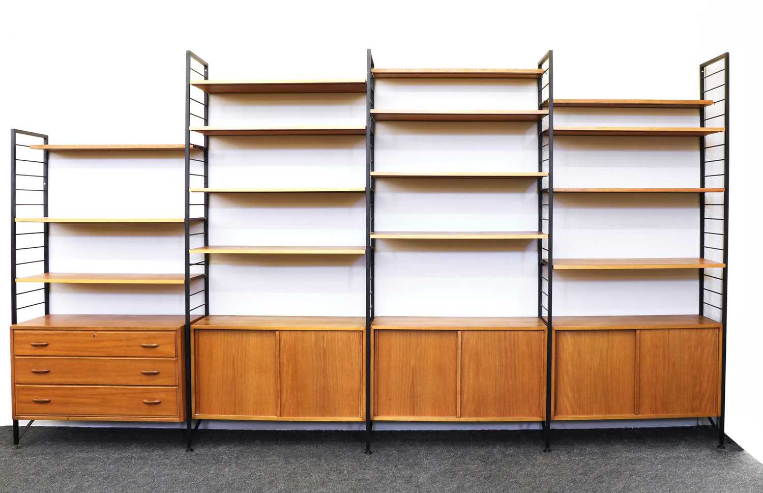 Lot 264 - A Staples' teak and satin black metal Ladderax three-section wall unit