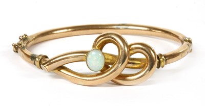 Lot 1 - A gold opal set hollow hinged bangle